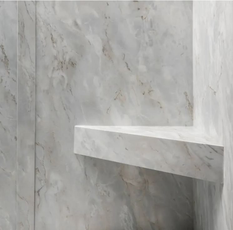 Integrated bench in a light marble-look shower surround