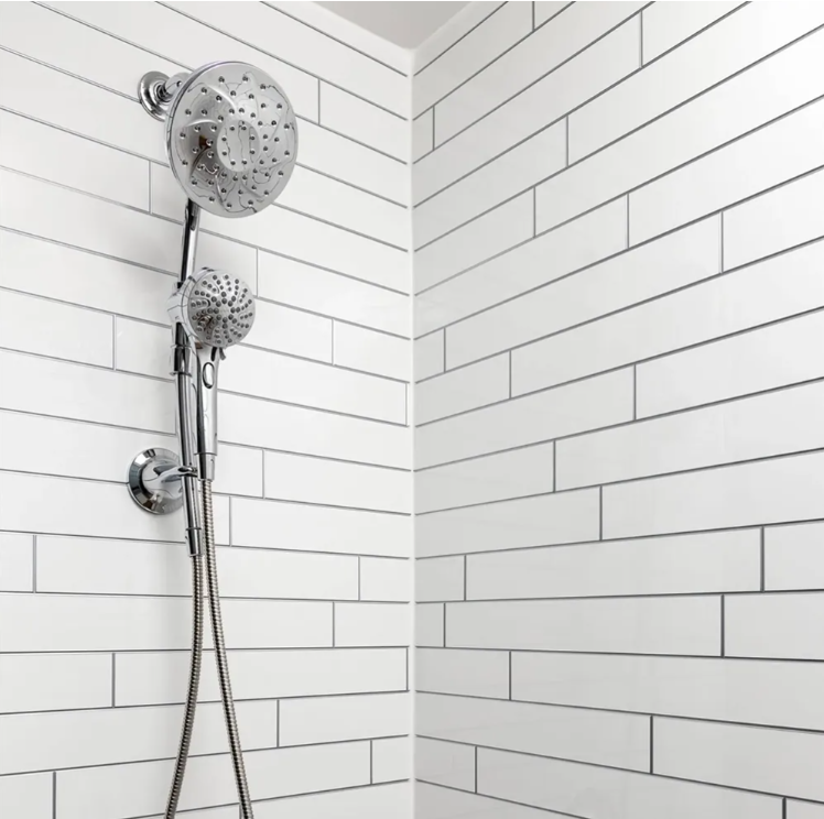 Bright white tile-look shower with chrome handheld shower fixtures