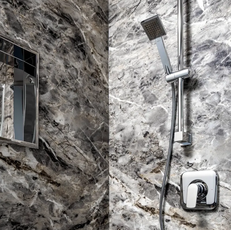 Stone-look shower wall system with polished chrome controls